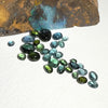 This parcel of 30 pieces of natural unheated tourmaline ranges from light teal blue to mid green to dark teal. They are all eye clean and assorted size cabochon cut.