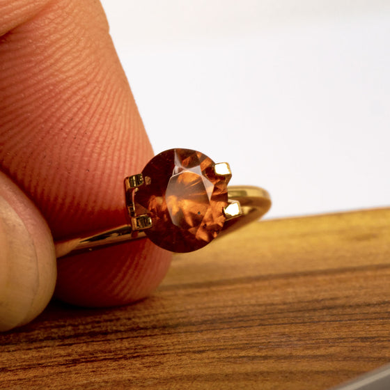 This warm toned natural zircon has a burnt amber feel about its colour