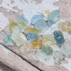 These parcels are a mix of natural, unheated aquamarine, helidor, green beryl and goshenite from Nigeria. This material has moderate inclusions, but is very gemmy material and a great choice for anyone looking to get into gem cutting!