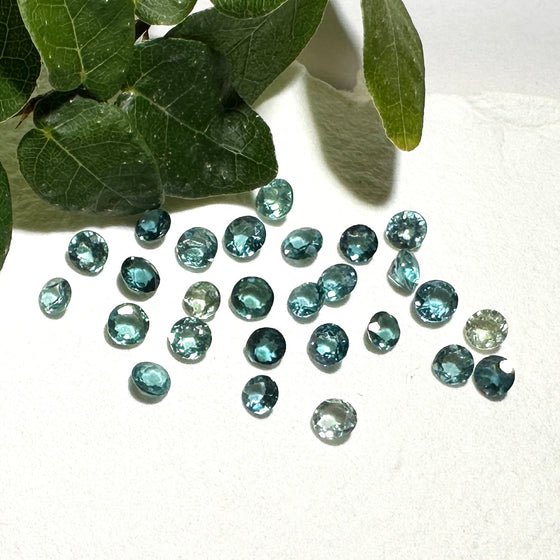 This parcel of 27 round cuts of natural unheated tourmaline ranges from light green to pale teal blue.&nbsp; They are all eye clean. The depth varies.