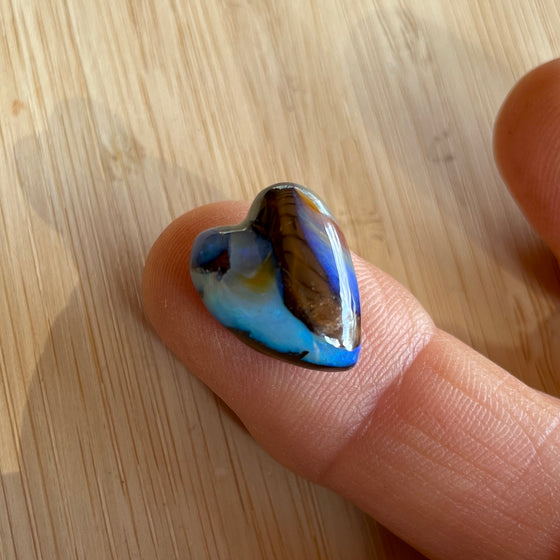 8.75ct Heart Shape Boulder Opal, this heart has swirling patterns of dark blue, light blue gold and brown, the colour is also on the sides making it a perfect pendant piece.