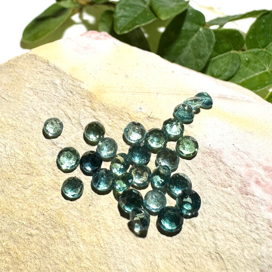 This parcel of 27 round cuts of natural unheated tourmaline ranges from light green to pale teal blue.&nbsp; They are all eye clean. The depth varies.