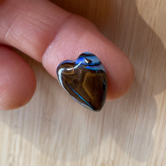 8.75ct Heart Shape Boulder Opal, this heart has swirling patterns of dark blue, light blue gold and brown, the colour is also on the sides making it a perfect pendant piece.