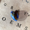 8.75ct Heart Shape Boulder Opal, this heart has swirling patterns of dark blue, light blue gold and brown, the colour is also on the sides making it a perfect pendant piece.