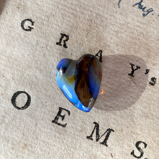 8.75ct Heart Shape Boulder Opal, this heart has swirling patterns of dark blue, light blue gold and brown, the colour is also on the sides making it a perfect pendant piece.
