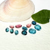 This parcel of 11 mixed cuts of natural unheated tourmaline in teal blue and pink. They are all eye clean. The depth varies.