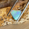 2.05 heart shaped crystal opal, this small bright heart has bright flashes of green, there is a darker line on one side.