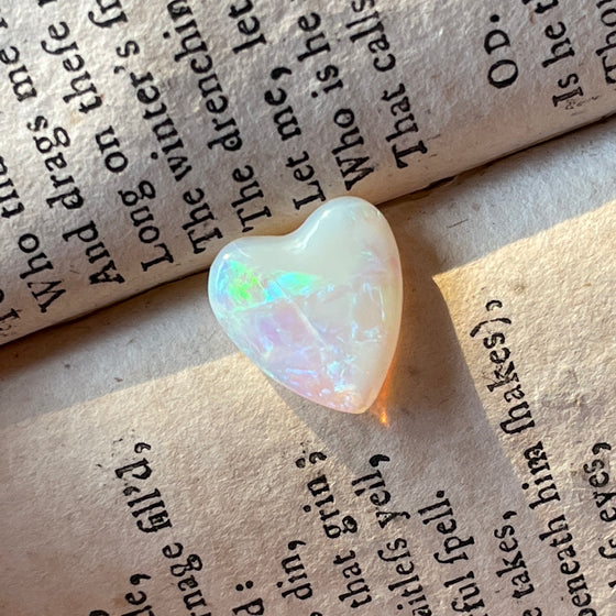 3ct Heart Shape Crystal Opal, this heart shaped opal has a great flash of bright green on one side, with more green and purple sparkle through it.