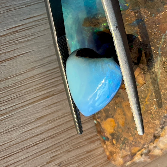 7.35ct Heart Shape Boulder Opal with clear blue green softly swirling patterns on the surface, the colour goes around the side as well. 