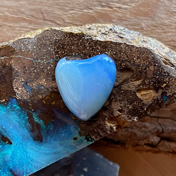 7.35ct Heart Shape Boulder Opal with clear blue green softly swirling patterns on the surface, the colour goes around the side as well. 