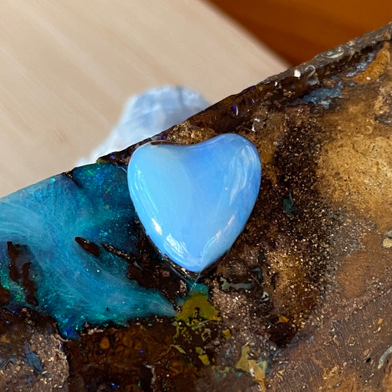 7.35ct Heart Shape Boulder Opal with clear blue green softly swirling patterns on the surface, the colour goes around the side as well. 