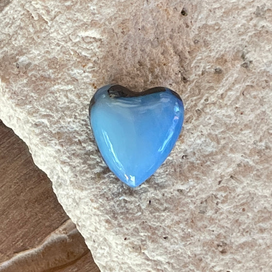 7.35ct Heart Shape Boulder Opal with clear blue green softly swirling patterns on the surface, the colour goes around the side as well. 