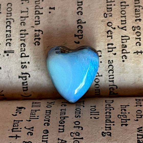 7.35ct Heart Shape Boulder Opal with clear blue green softly swirling patterns on the surface, the colour goes around the side as well. 