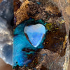 5ct Heart Shape Boulder Opal, this tiny heart is clear misty blue across the top with a slightly darker blue at the base. The cutter has used the patterns in the opal to enhance the piece.