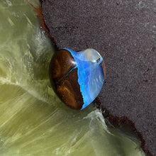  5.4ct Heart Shape Boulder Opal, it has been cut and polished leaving a line down the centre and bright blue on the other. The back also has interesting patterns, so this could be used as a double sided pendant.