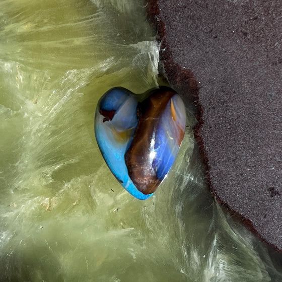 8.75ct Heart Shape Boulder Opal, this heart has swirling patterns of dark blue, light blue gold and brown, the colour is also on the sides making it a perfect pendant piece.