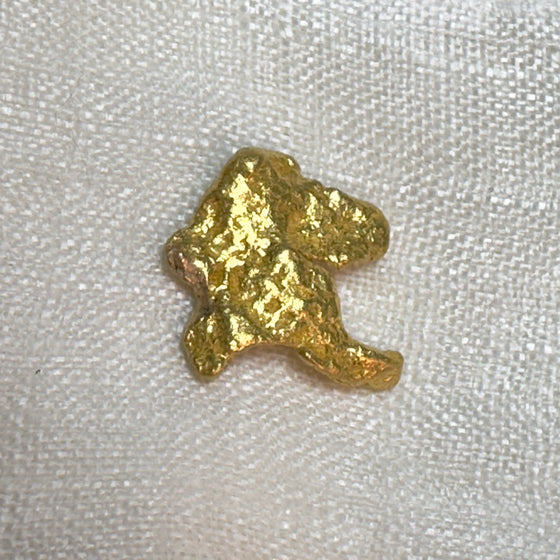 This interesting 9.784gr gold nugget was found by a metal detectorist and dug by hand in Clermont, Queensland, Australia.  Approx. 96% pure gold, with possible quartz inclusion.