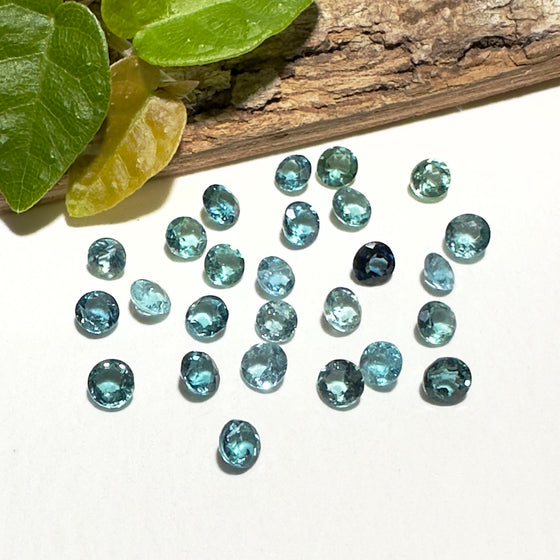This parcel of 27 round cuts of natural unheated tourmaline ranges from light green to pale teal blue.&nbsp; They are all eye clean. The depth varies.