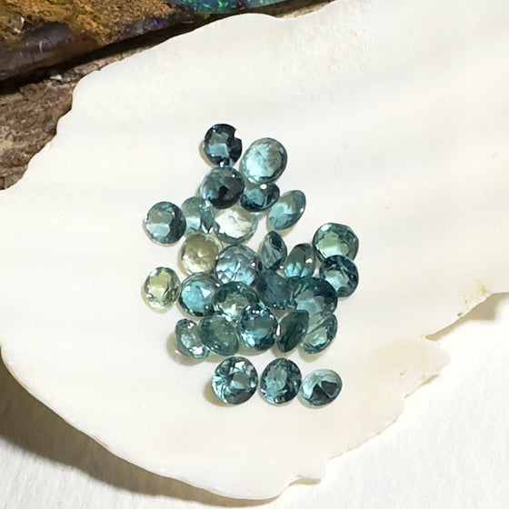 This parcel of 27 round cuts of natural unheated tourmaline ranges from light green to pale teal blue.&nbsp; They are all eye clean. The depth varies.