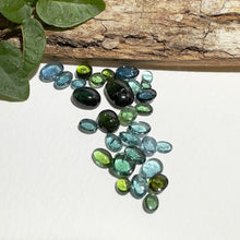  This parcel of 30 pieces of natural unheated tourmaline ranges from light teal blue to mid green to dark teal. They are all eye clean and assorted size cabochon cut.
