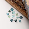 This parcel of 12 tiny natural unheated tourmaline are mostly pale green and blue. They are all eye clean and are assorted sizes between 2-3mm