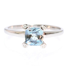  A lovely subtle design this Aquamarine ring has a square stone is high set and has a small diamond on each corner. Very chic and sophisticated.