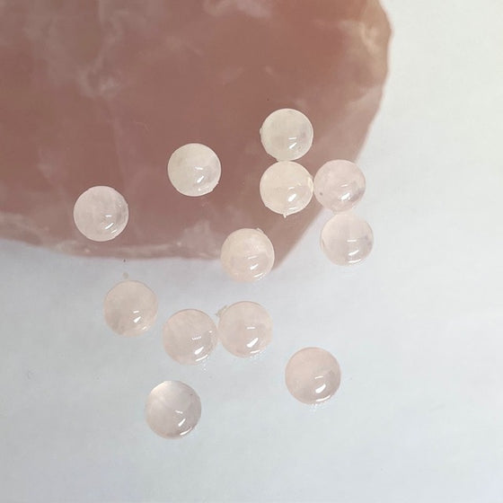 A set of 12 pieces of .6mm round cabs, pale pink. Suitable for rings.