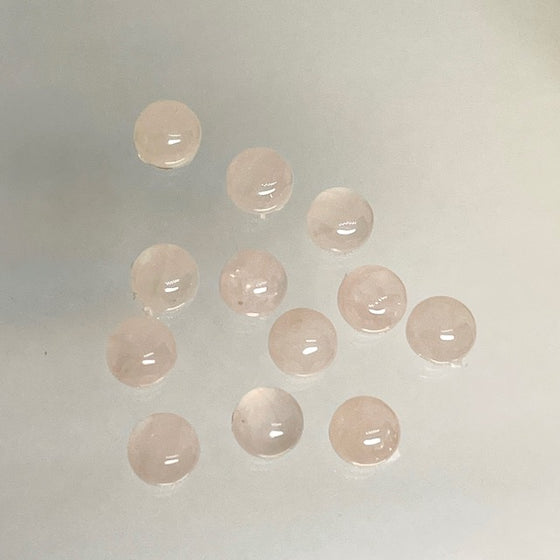 A set of 12 pieces of .6mm round cabs, pale pink. Suitable for rings.