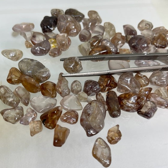 This Australian Zircon Rough has a mixture of pale pinkish, yellowish and near colourless stones. Most are lightly to moderately included. These have not been treated in any way other than being tumbled.